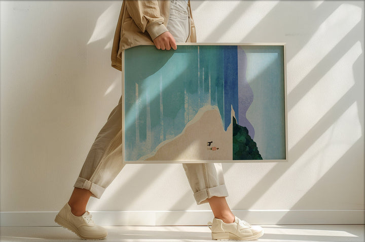 Person holding an artwork of a mountain landscape in a minimalistic setting