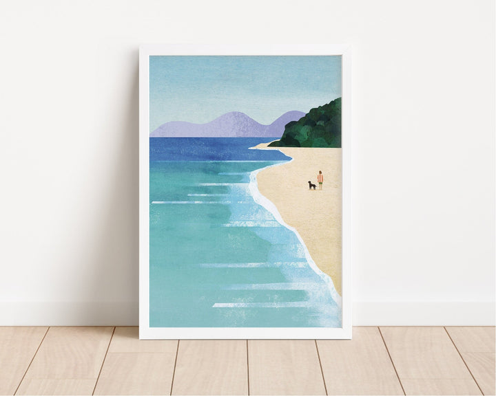 Artwork of a beach scene with a person and dog on a white wall.