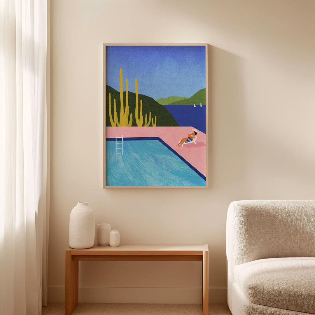Artwork of a pool scene on a wall above a side table with decorative items.