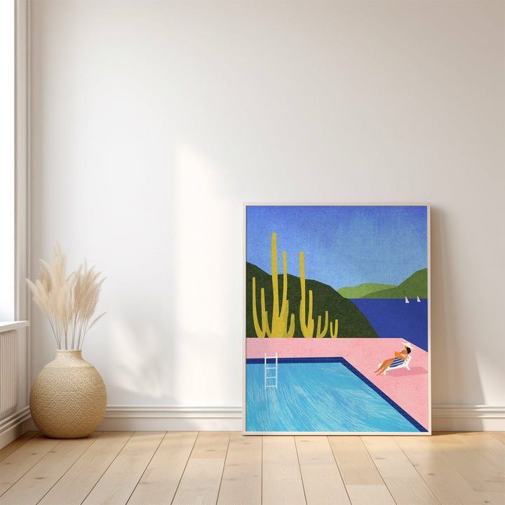 Artwork of a pool scene with mountains on a white wall.