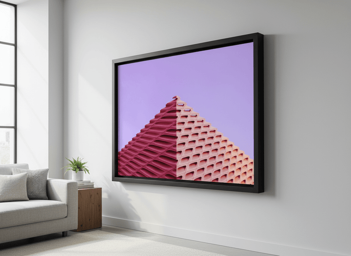 Modern wall art styled above a sofa in a neutral living room
