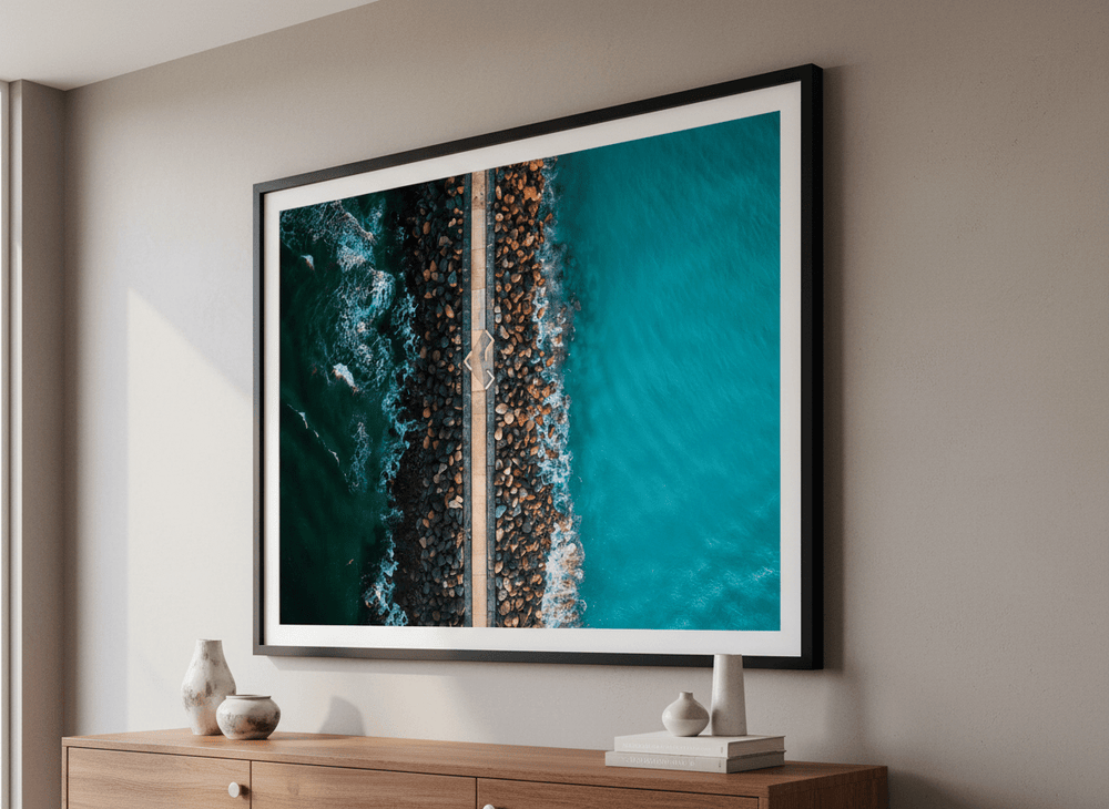 Modern wall art styled above a sofa in a neutral living room