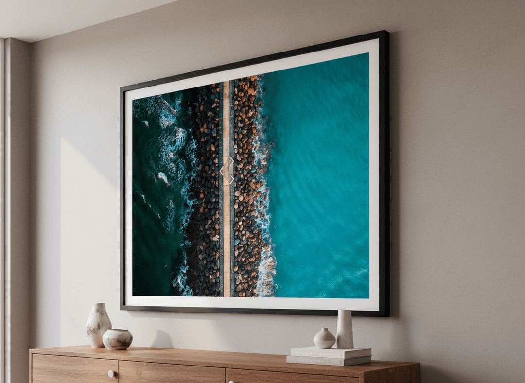 Modern wall art styled above a sofa in a neutral living room
