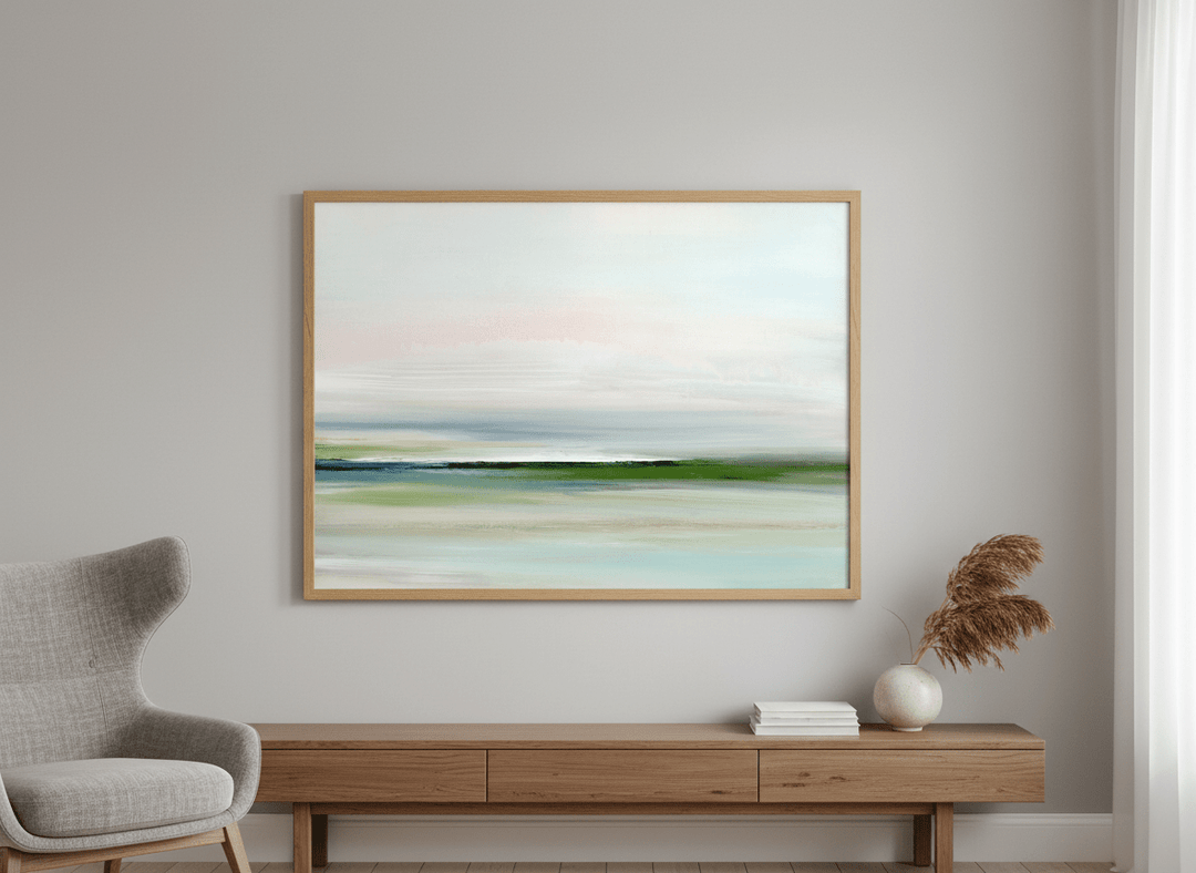 Modern wall art styled above a sofa in a neutral living room