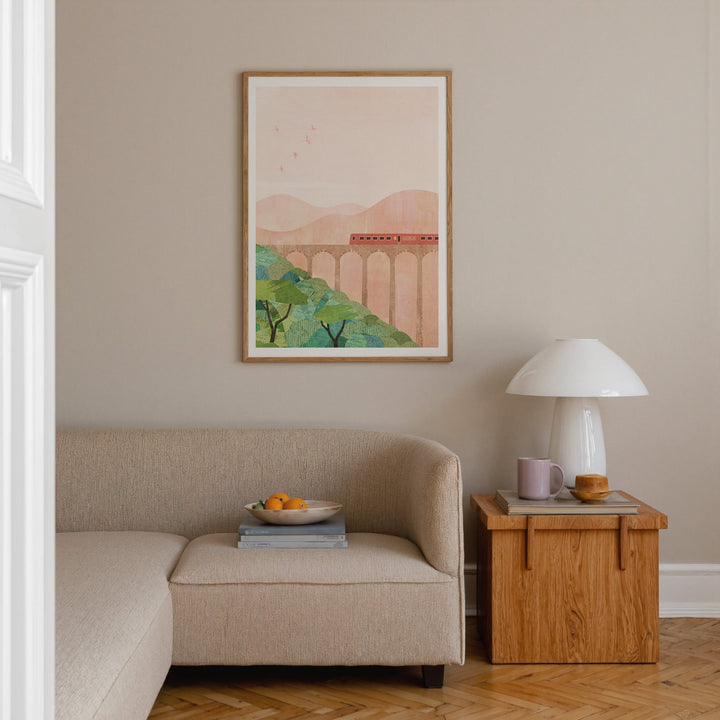 Living room with beige sofa, wooden side table, and an artwork on the wall.