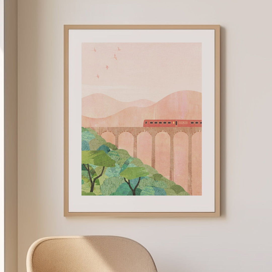 Modern interior with a beige armchair, small table, and artwork on a white wall.