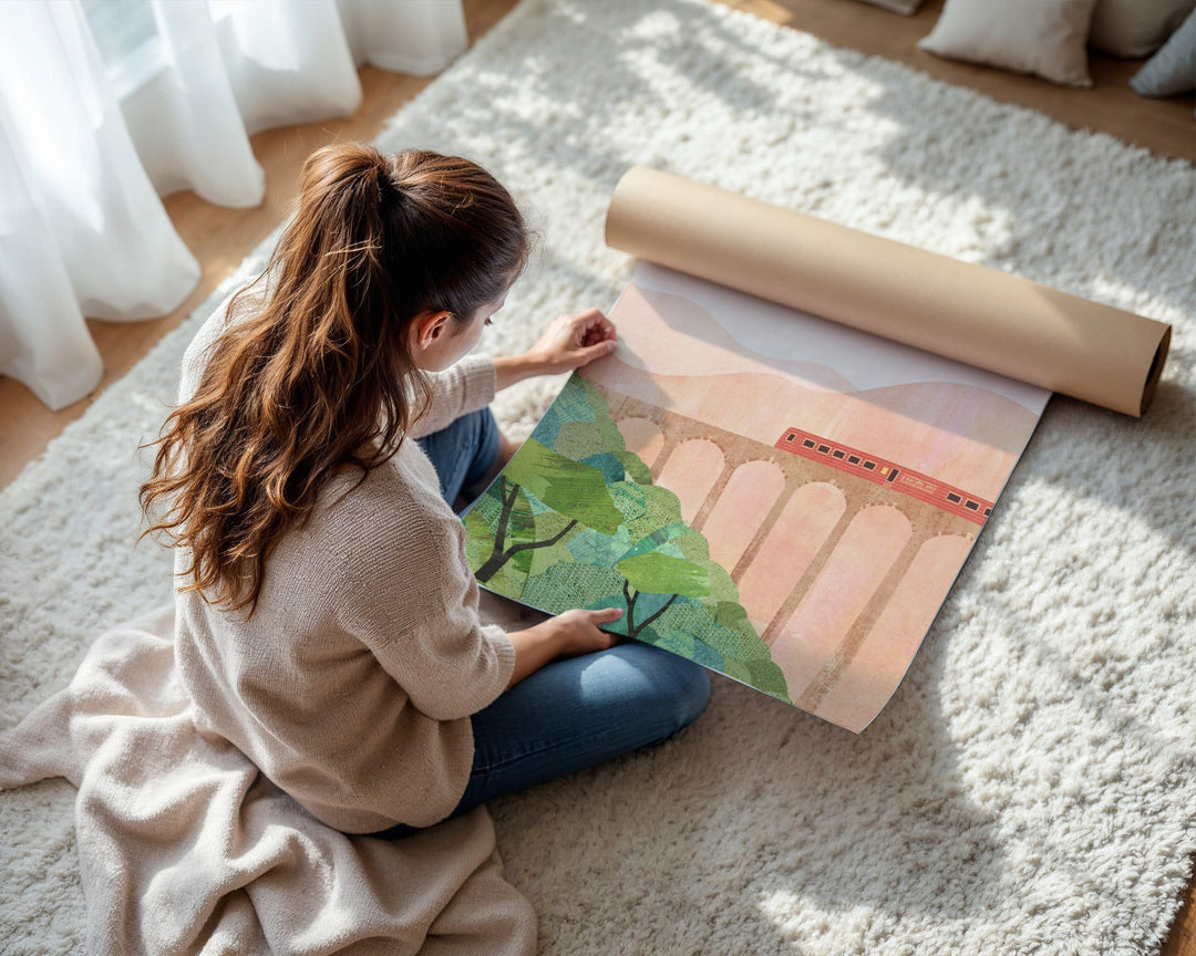 Woman unrolling a large poster of a scenic landscape on a carpeted floor.
