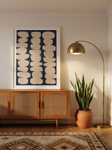 Modern wall art print standing on a sideboard in a mid-century home office