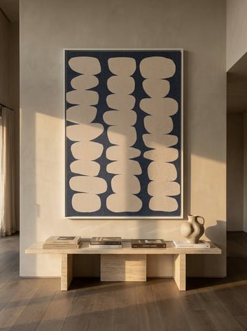 Oversized statement canvas wall art with a white surround styled on the wall in a luxe living room