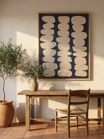 Oversized statement canvas wall art with a natural timber surround styled on the wall in a Mediterranean home office