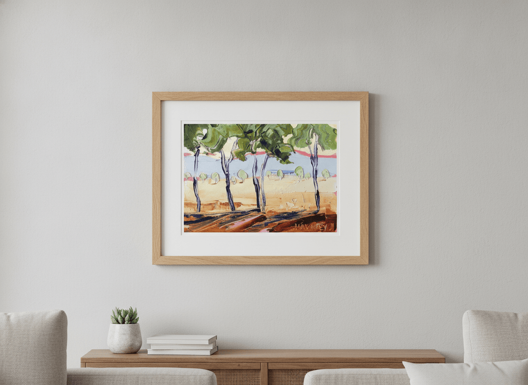 Modern wall art styled above a sofa in a neutral living room