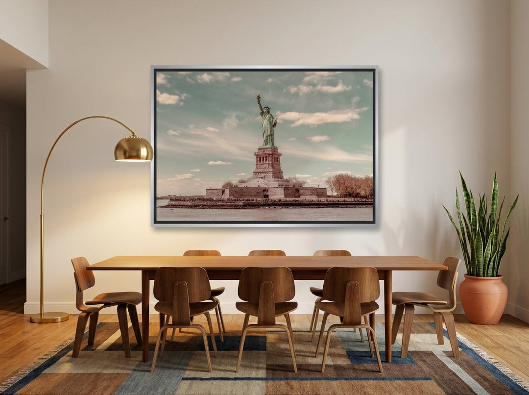Oversized statement canvas wall art with a silver leaf surround styled on the wall in a mid-century dining room
