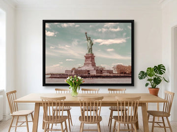 Oversized statement canvas wall art with a black surround styled on the wall in a bright Scandinavian dining room