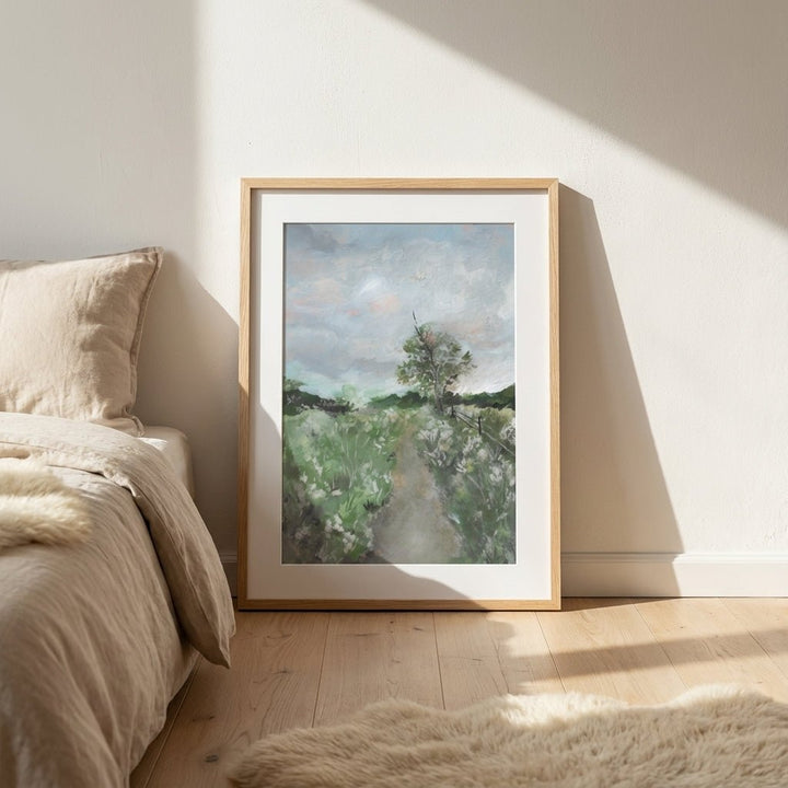 Landscape painting on a wall in a bedroom with natural light