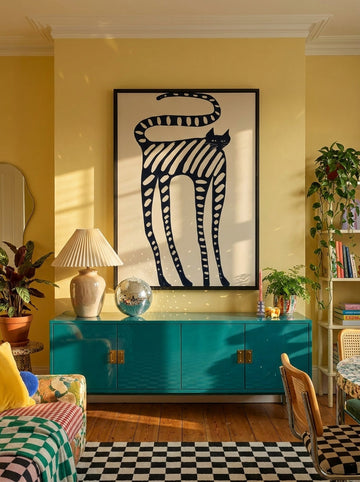 Oversized statement modern wall art print styled on the wall in a colourful eclectic living room