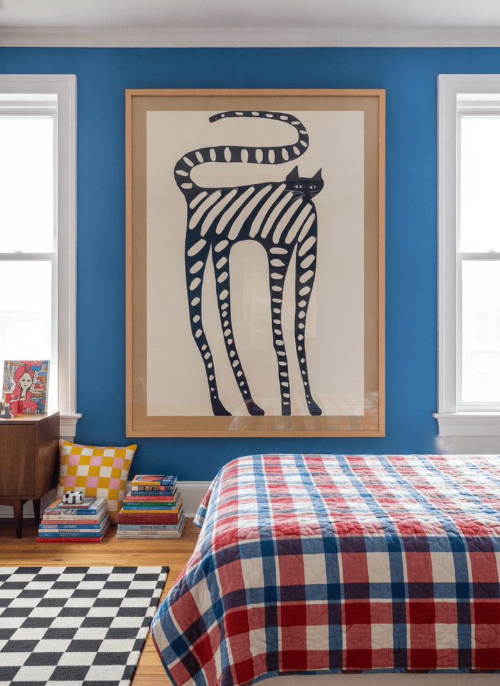 Oversized statement modern wall art print styled on the wall in a colourful eclectic bedroom