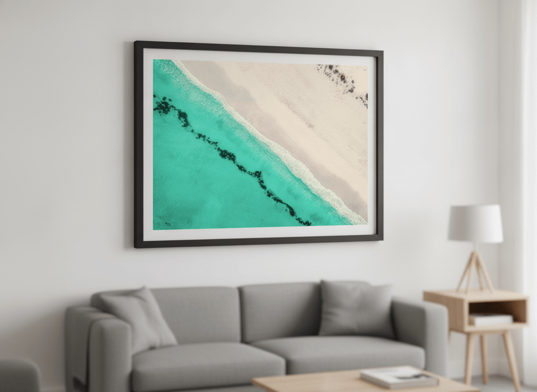 Modern wall art styled above a sofa in a neutral living room