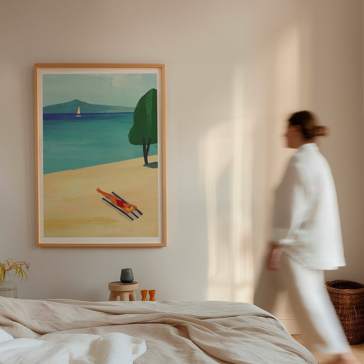Woman walking past a painting of a beach scene in a room with neutral decor.