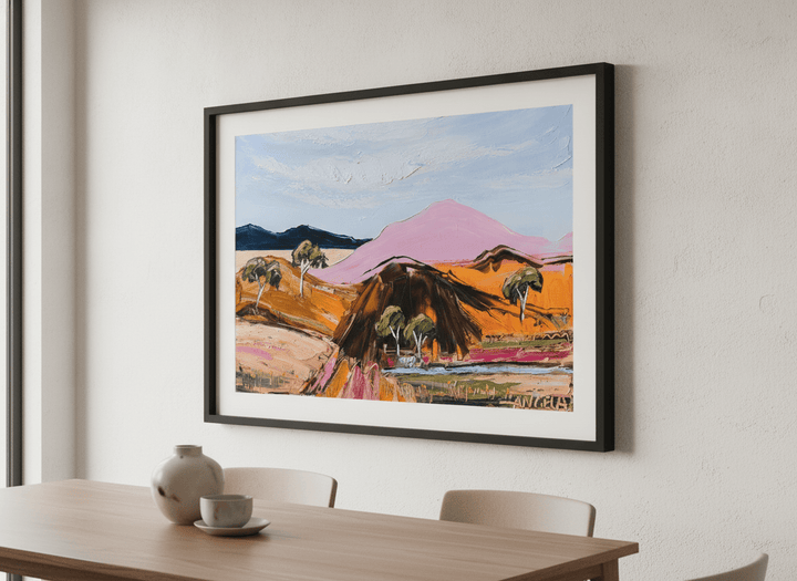 Wall art styled above a dining table in a contemporary home