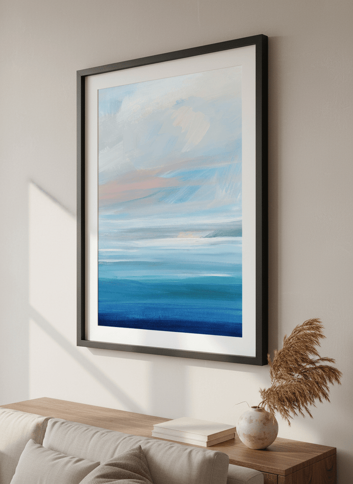 Modern wall art styled above a sofa in a neutral living room