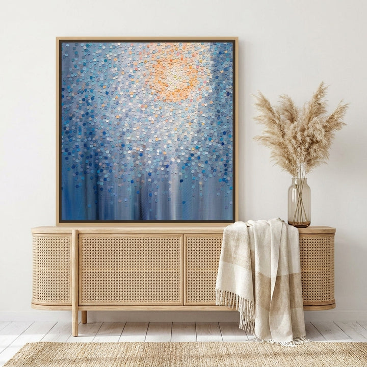 Canvas wall art with a natural timber surround standing on a sideboard in a coastal bedroom