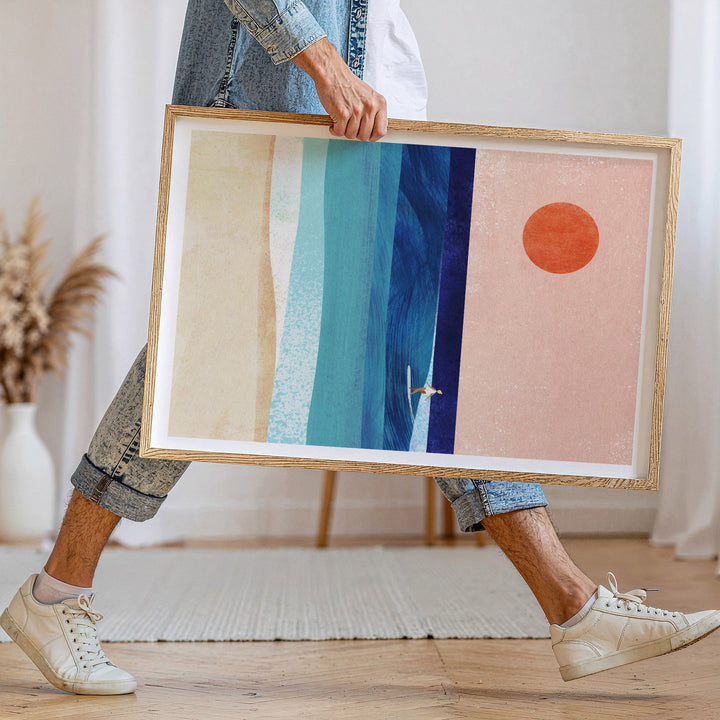 Person holding  abstract art piece with geometric shapes in a home setting