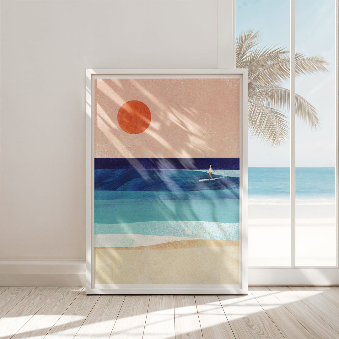 Artwork of a beach scene with a palm tree and sun, displayed on a wall.