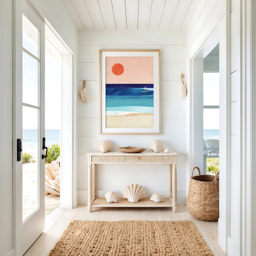 Nautical-themed interior with a console table, shell decor, and beach-themed artwork.