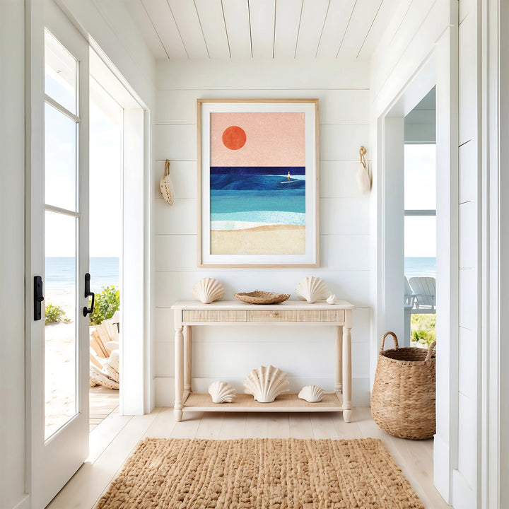 Nautical-themed interior with a console table, shell decor, and beach-themed artwork.