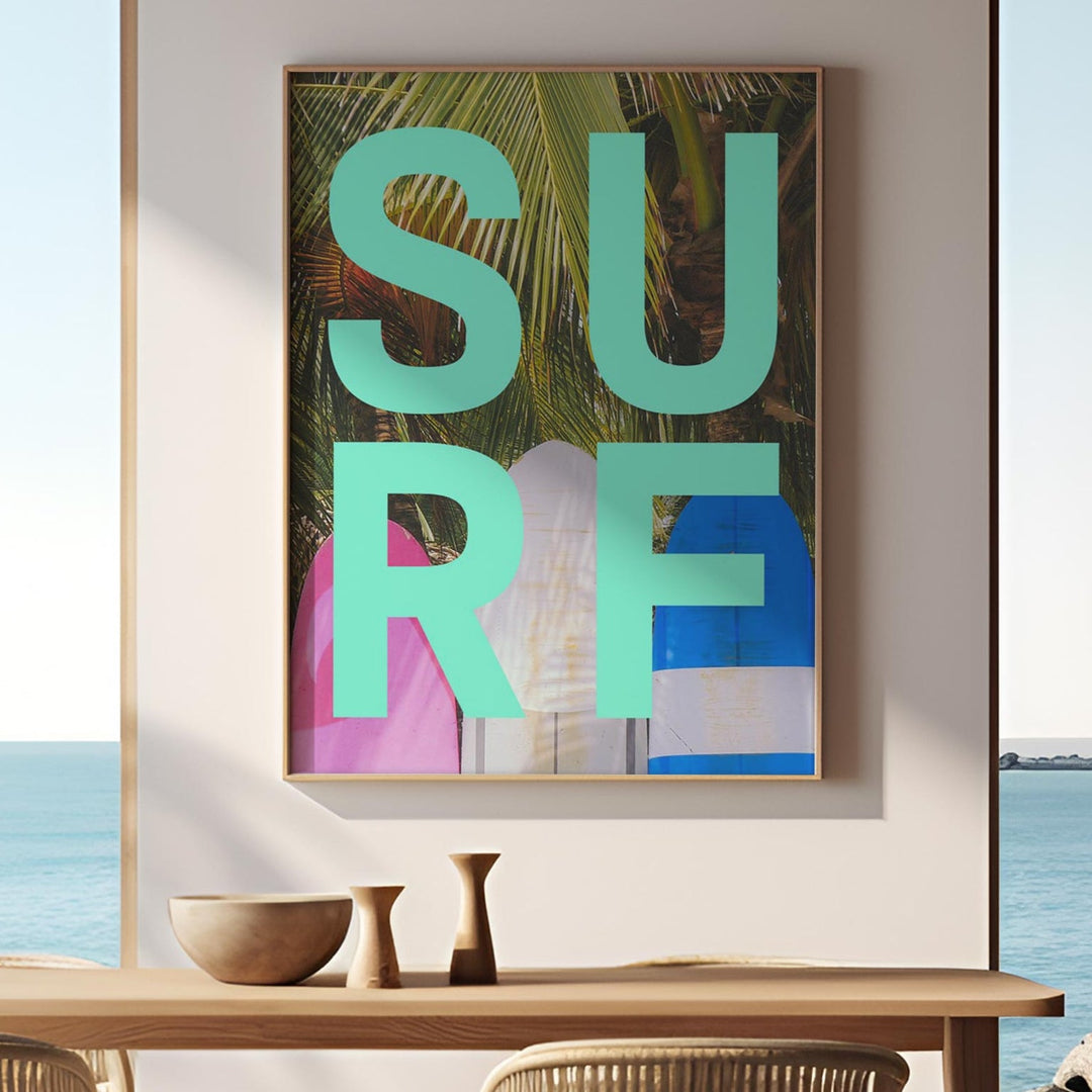 Modern dining room with 'SURF' artwork, table, chairs, and ocean view.