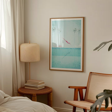 Room interior with a lamp, books, and a picture on the wall.
