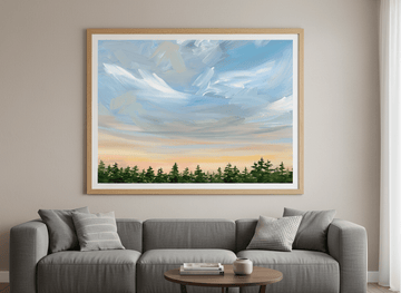 Modern wall art styled above a sofa in a neutral living room