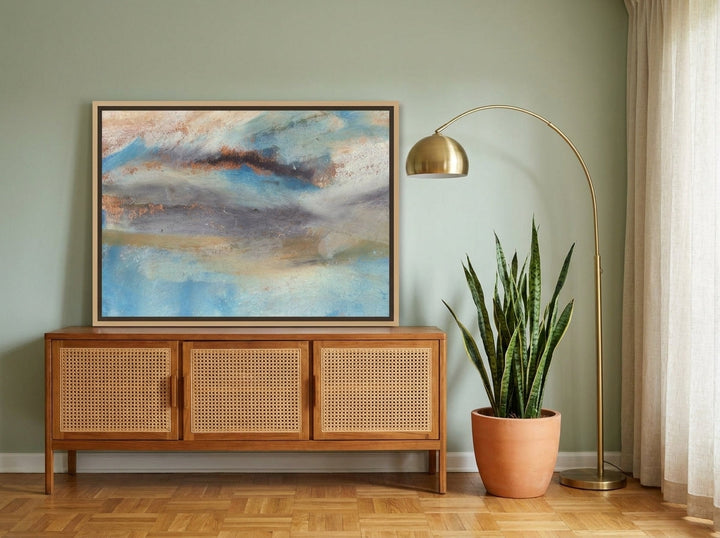 Canvas wall art with a natural timber surround standing on a sideboard in a mid-century home office