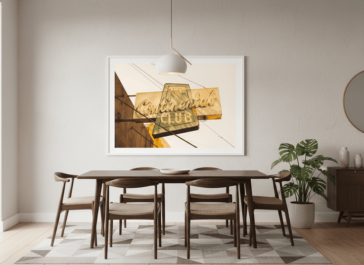 Wall art styled above a dining table in a contemporary home