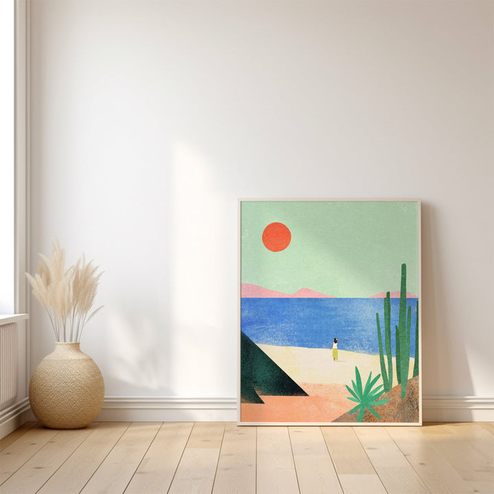 Artwork of a desert scene with a red sun, blue sky, and cacti on a white wall.