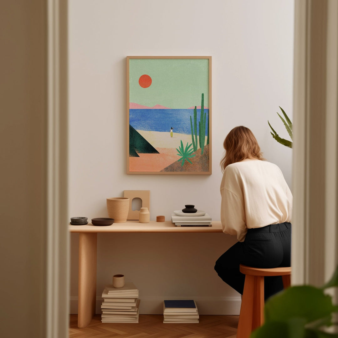 Person sitting at a desk with a colorful abstract painting on the wall