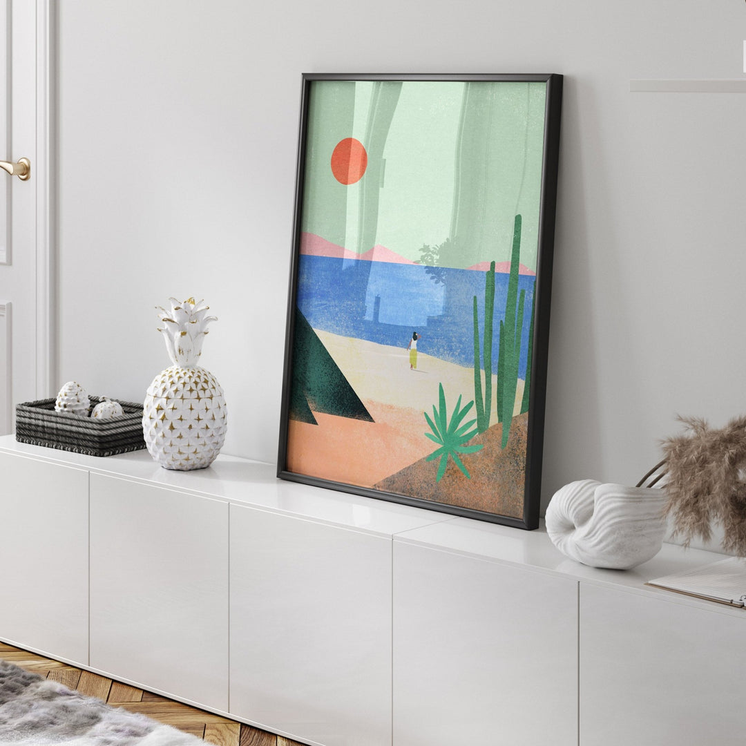 Abstract artwork on a white wall above a white cabinet.