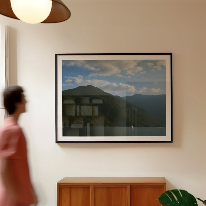 guy walking toward printed photo on wall