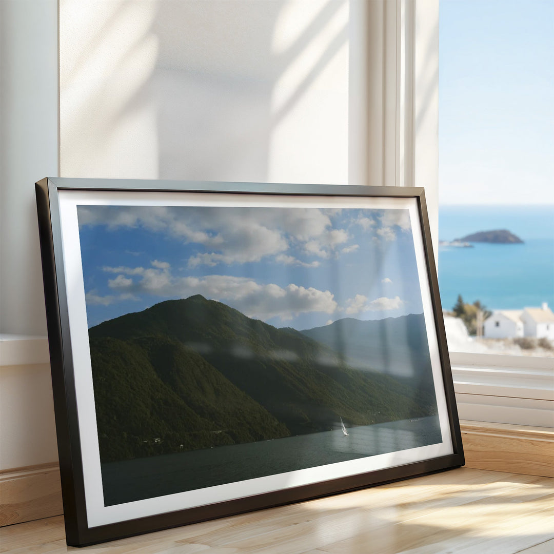 printed photo of mountain on floor leaning against wall
