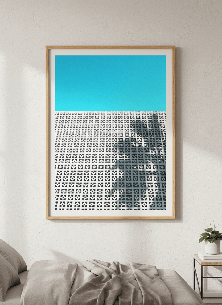Minimalist artwork displayed in a calm, light-filled bedroom interior