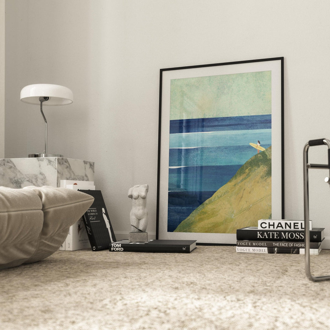 Artwork on a shelf with books and decorative items in a room.