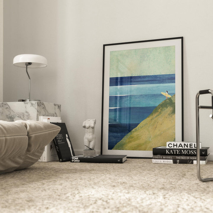 Artwork on a shelf with books and decorative items in a room.