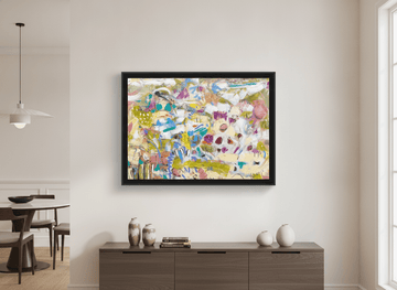 Wall art styled above a dining table in a contemporary home