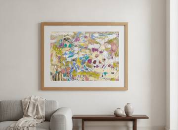 Modern wall art styled above a sofa in a neutral living room