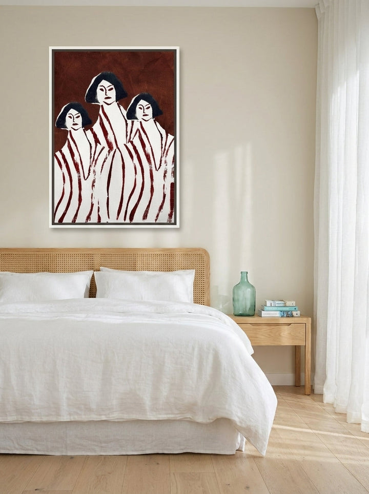 Canvas wall art with a white surround styled on the wall in a coastal bedroom