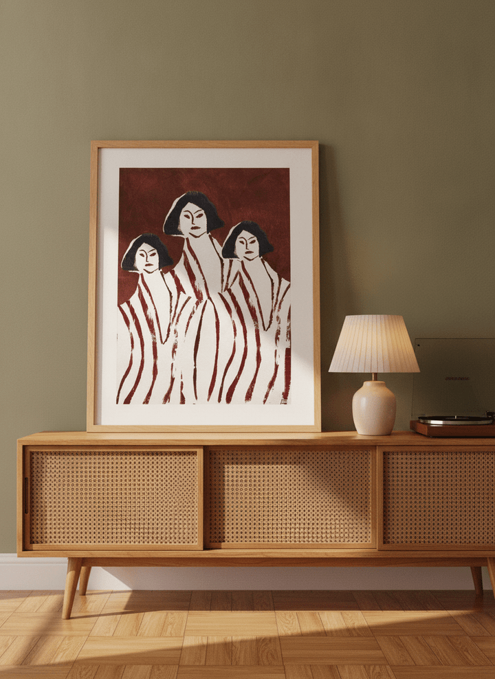 Modern wall art print standing on a sideboard in a mid-century home office