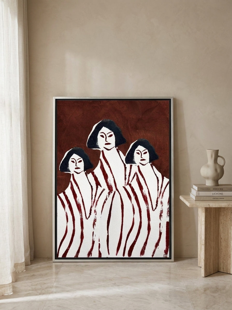 Canvas wall art with a silver leaf surround leaning against the wall in a luxe living room