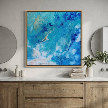 Canvas wall art with a natural timber surround styled in a clean minimalist bathroom