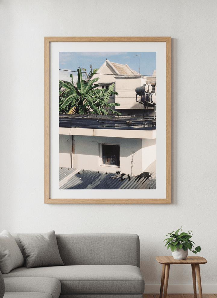 Modern wall art styled above a sofa in a neutral living room