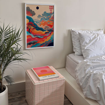Modern bedroom with a bed, side table, and colorful abstract art on the wall.